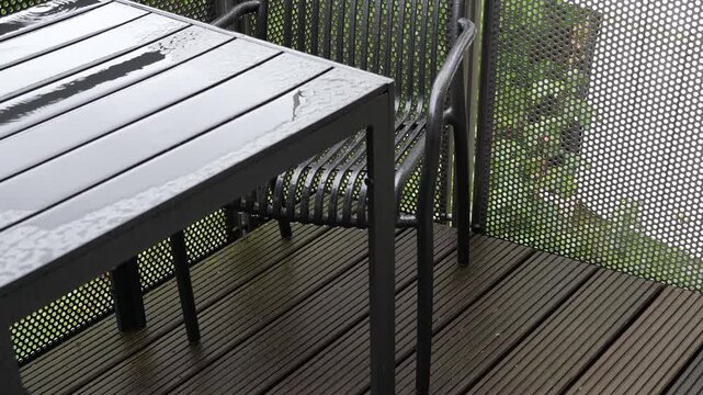 Modern Patio Furniture on Wooden Terrace Deck During Rainy Day