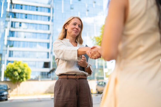 Businesswomen shaking hands completing a successful deal