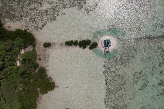 Aerial View of Excavator Working on Tiny Tropical Sandbar