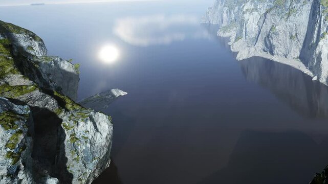 The scene shows a rocky shore next to still water. The sun reflects off the surface. Distant hills are visible. The time is dusk, creating a soft look over the landscape.