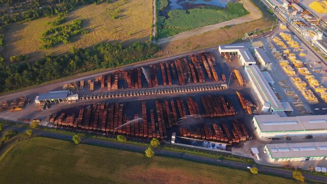 Aerial view of wood log stacks being sprinkled with water at a paper mill in Steti, Usti nad Labem Region, Czechia.