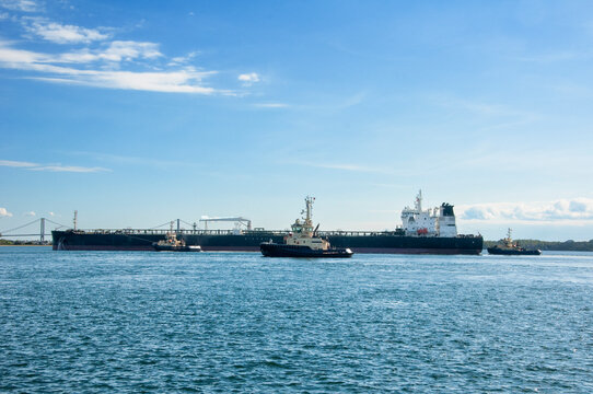 Industrial crude oil fuel tanker ship at terminal industrial port, Tanker ship and tugboats unloading crude oil, Industry refinery Fredericia, Denmark	
