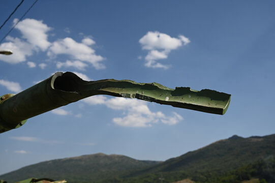 The barrel of a tank destroyed in battle. Destroyed tank in war. The barrel of a tank destroyed in battle in a war zone. Damaged and wrecked tank gun barrel after combat and explosions.