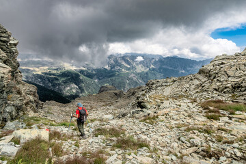 Fototapeta premium Hiker on highway of Valmalenco, summer landscape in the Central Alps