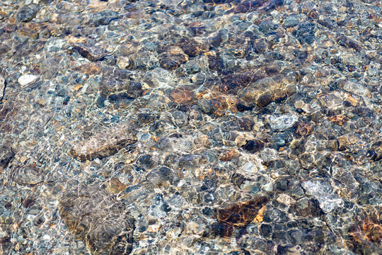 Transparent sea clear water with ripples. Sea water background. Water waves in nature. Rippled ocean background. Ripple on sea water in summer