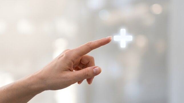 A close-up view of a person pointing at a glowing plus symbol on a transparent glass interface.