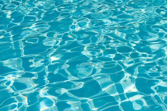 Refreshing blue swimming pool. Transparent clear water background. Water background in the swimming pool. Water in the pool. Summer vacation. Ripped water at summer vacation