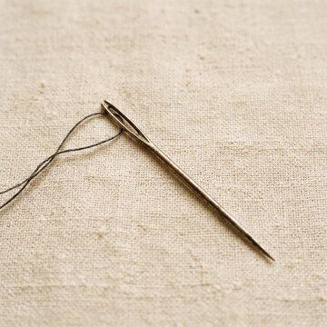 needle on a wooden surface