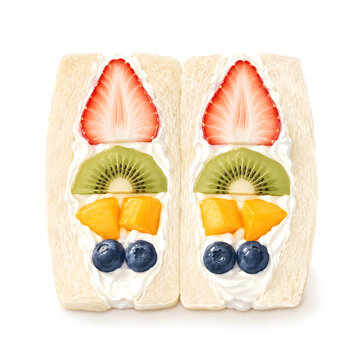 Japanese fruit sando halves with strawberries, kiwi, mango, blueberries, and whipped cream, isolated on white background.