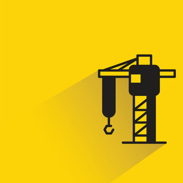 construction crane icon with shadow on yellow background