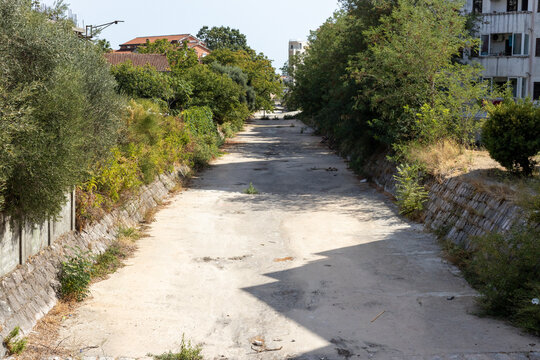 A completely dried-up urban canal bed in the Mediterranean region.
