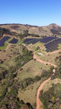 Aerial view of a solar energy farm on a mountain.