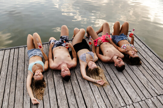 Friends Enjoy Summer on the River Dock While Relaxing and Spending Time Together