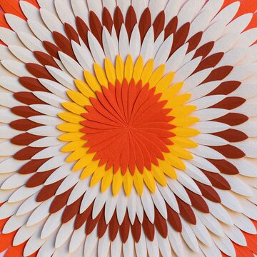 Paper-cut mandala with layered floral petals in warm autumn tones on a textured surface, featuring a tactile folded relief for craft and meditation