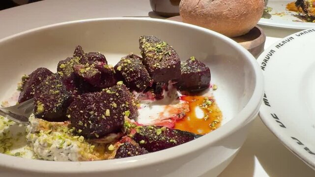 Roasted Beets Served Over Whipped Goat Cheese Sprinkled with Pistachios