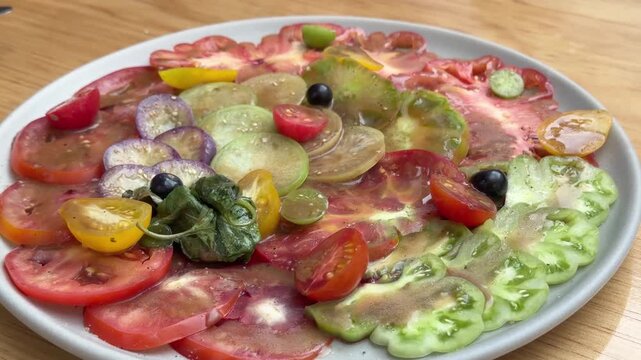 Vibrant Oaxacan Heirloom Tomato Carpaccio Salad Plated on Round Dish