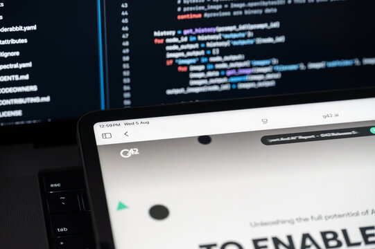 G42 Ai company web page on program code background