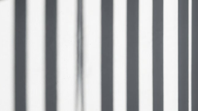Minimalist architectural shadow play on white wall creates rhythmic vertical stripes suitable for modern interior design presentations and clean geometric background compositions.