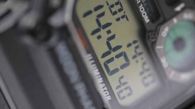 Extreme close-up of a digital watch face with seconds counting up on the electronic display