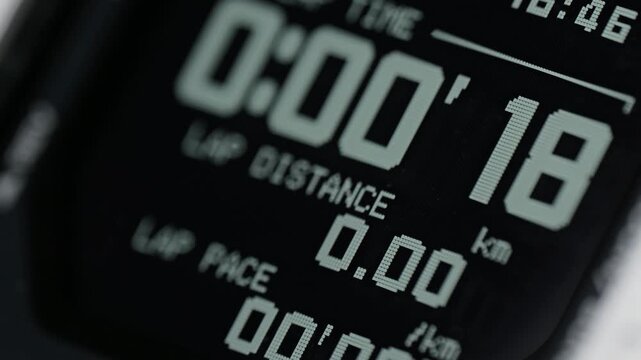 Extreme close-up of a digital stopwatch on a sports watch counting up seconds for training