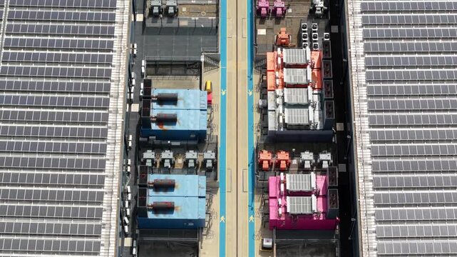 Aerial view of the NTT 3 Data Center featuring extensive rooftop solar panel arrays and industrial cooling infrastructure in Hemel Hempstead, England, United Kingdom.