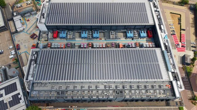 Aerial view of the NTT 3 Data Center featuring extensive rooftop solar panel arrays and industrial cooling infrastructure in Hemel Hempstead, England, United Kingdom.