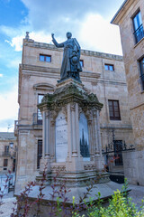 A bronze historical statue stands on an ornate stone pedestal © wundermann