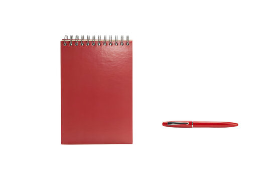 Red spiral bound notebook and matching red ballpoint pen stationery set isolated on a transparent background