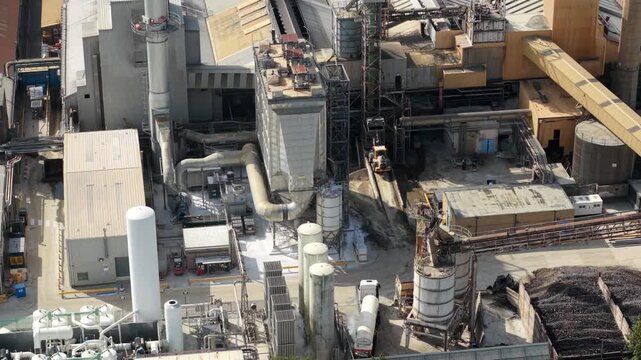 Aerial view of cryogenic liquid nitrogen tanks and ambient air vaporizers at an industrial facility with storage silos and pipes in Harlow, England, United Kingdom.