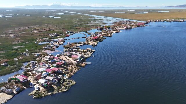 Overhead drone footage capturing the intricate layout of the Uros floating islands made of totora reeds in Peru.