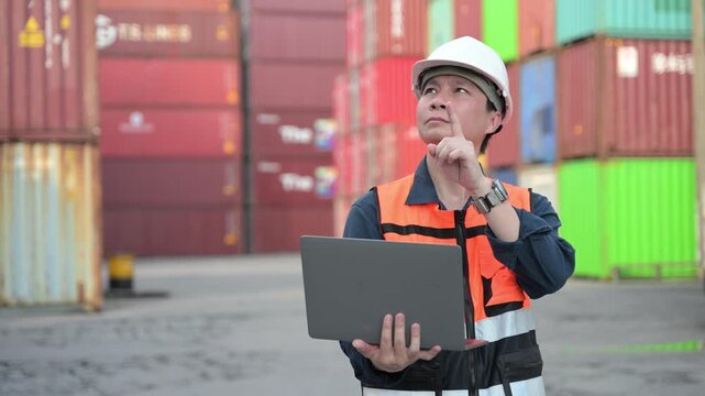 One female logistics worker uses a two way radio and hand signals to direct cargo operations at a shipping container yard. Concept of logistics, freight transport, communication, and supply chain.