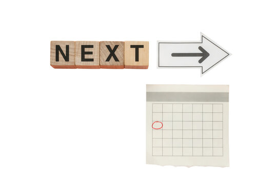 Wooden Blocks with the Word NEXT and a Calendar