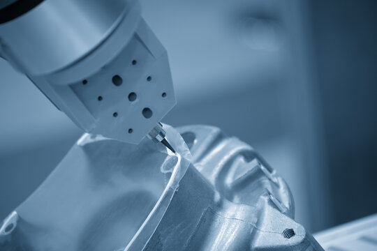 Glue sealing process on automotive parts assembly line using robotic system in blue tone lighting