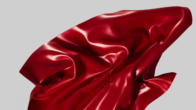 Graceful movement of luxurious crimson textile material creating vibrant wavy patterns.