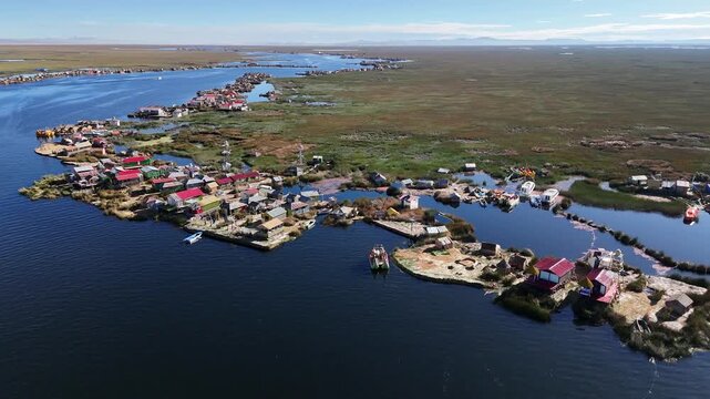 Overhead drone footage capturing the intricate layout of the Uros floating islands made of totora reeds in Peru.