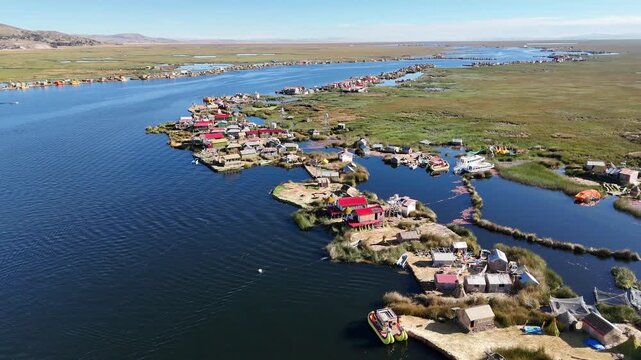Cinematic aerial view over the unique Uros floating reed islands on the deep blue waters of Lake Titicaca, Peru.