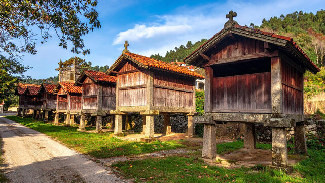 Traditional Portuguese Espigueiros Granaries in Scenic Rural Landscape Under Blue Sky