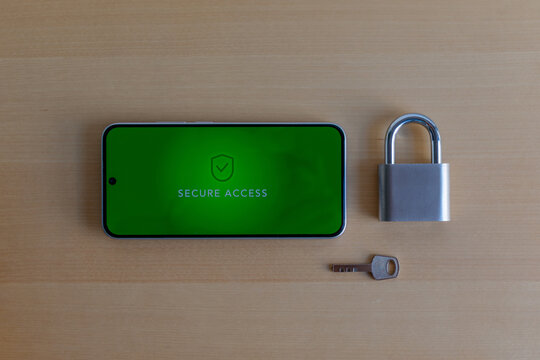 Smartphone with secure access screen padlock and key on desk