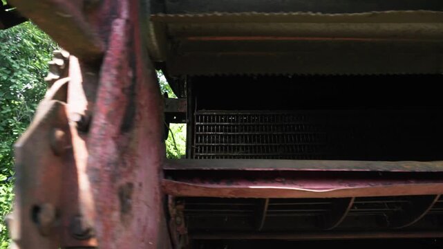 old red combine harvester repair threshing machine replacement of whips on the drum welding work to improve the efficiency of the unit