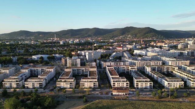 Aerial Side Flight along Heidelberg Bahnstadt with Bergheim, Neuenheimer Feld and Odenwald in Background, Germany