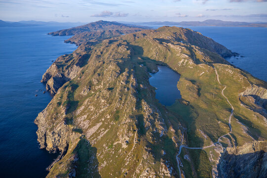 Aerial view of Sheep's Head Peninsula and Lough Akeen in County Cork Ireland. Rugged coastline of Sheep's Head Peninsula in West Cork with Lough Akeen lake along Wild Atlantic Way.