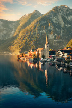 The iconic village Hallstatt, Austria, in early morning light. A gorgeous landscape with the mountains in the background of the houses and reflections in the water of the lake