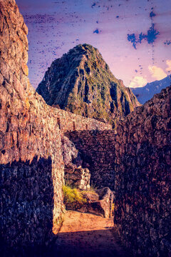 Peru, South America: Huayna Picchu (or Wayna Picchu), the iconic steep peak rising directly behind the Machu Picchu citadel in Peru seen through the stone ruins of the Lost City of the Incas