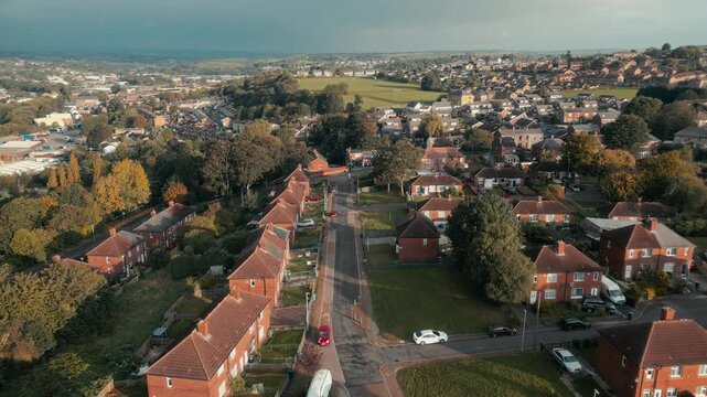 Aerial view of quiet suburban streets lined with red-brick homes