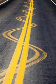 Yellow Road Lines Double Painted on Highway or Roadway with Curves Into the Distance
