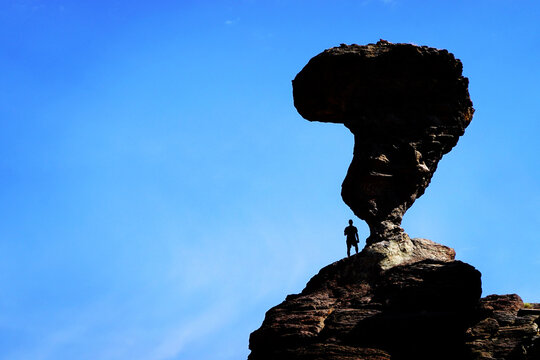 Balanced Rock with Silhouette of Person Standing Next to the Formation to Give it Scale and Size