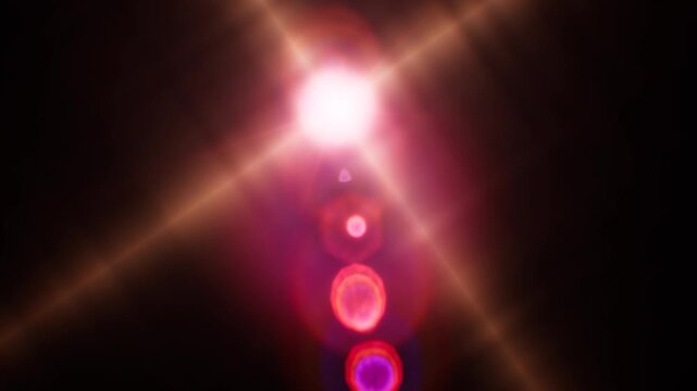 Realistic digital lens flare light effects illuminating a dark background.