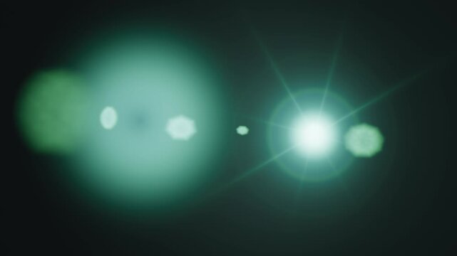 Bright green lens flare effect glowing brightly against a dark background