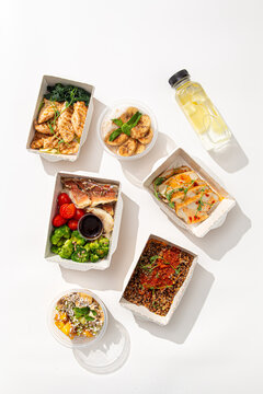 Set of healthy balanced food in disposable eco containers with meat fish vegetables grains and fruit dessert top view