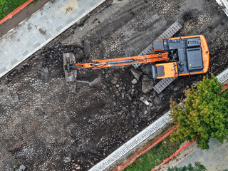 Daytime road construction and asphalt resurfacing with excavator in urban area © Marcin Ziółkowski